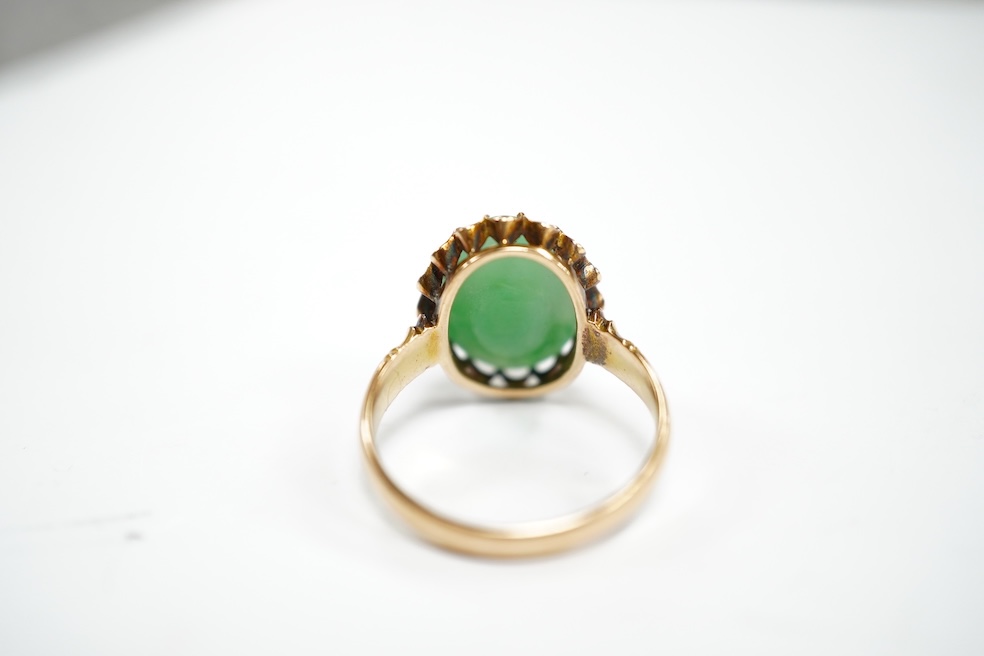 A mid 20th century yellow metal and single stone cabochon jade set ring, size Q, gross weight 5.6 grams. Condition - fair